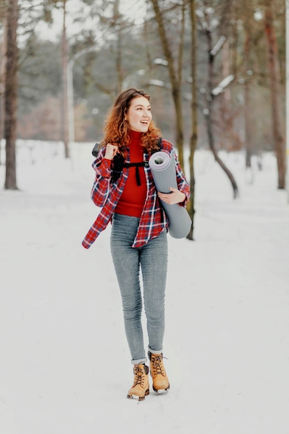 Full shot woman holding mat