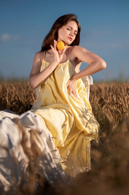 Full shot woman holding orange