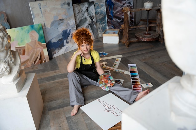 full shot woman holding paint palette