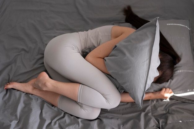 Full shot woman holding pillow