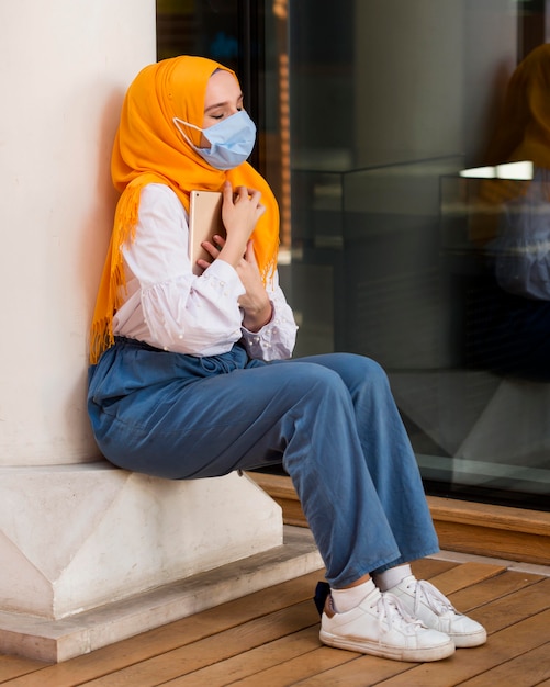 Full shot woman holding tablet