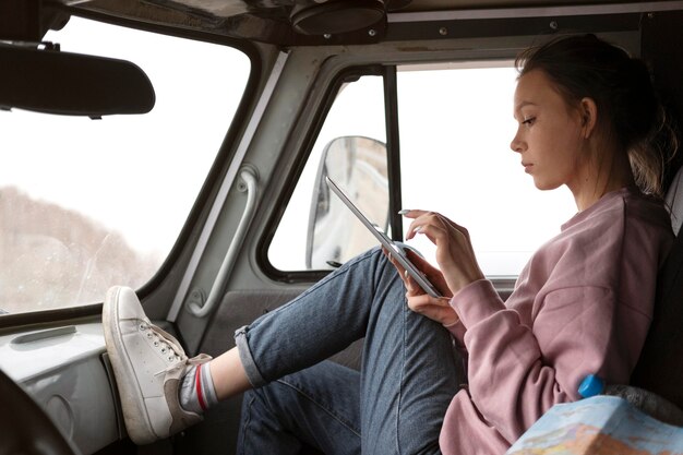 Full shot woman holding tablet