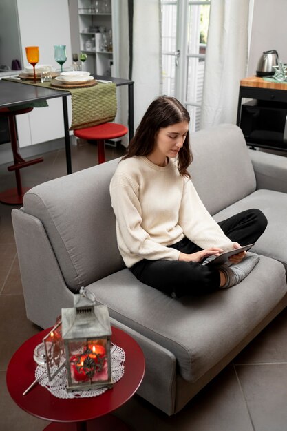 Full shot woman holding tablet