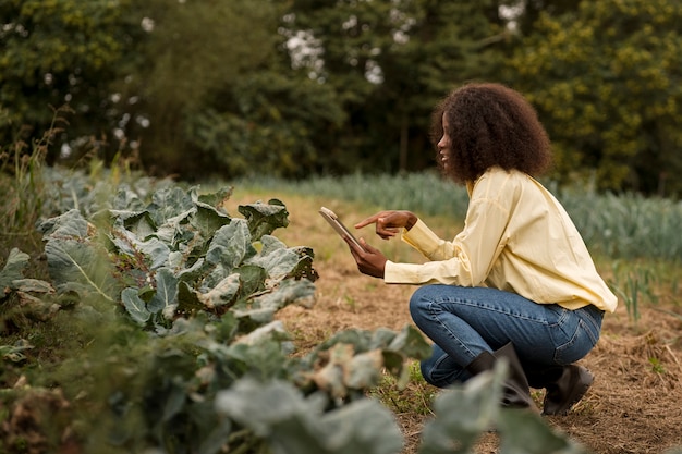 Full shot woman holding tablet