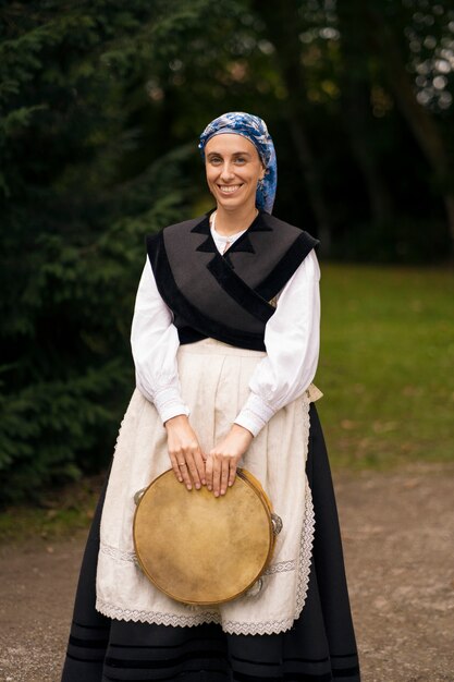 Full shot woman holding tambourine