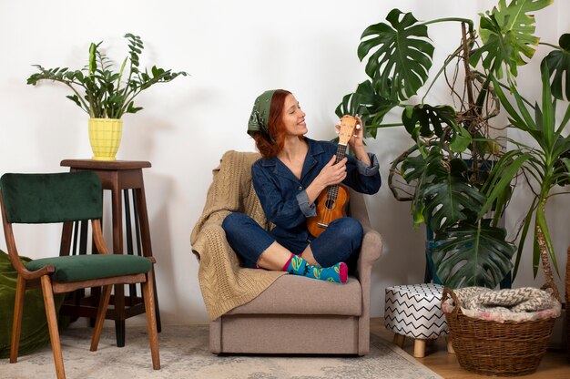 Full shot woman holding ukulele