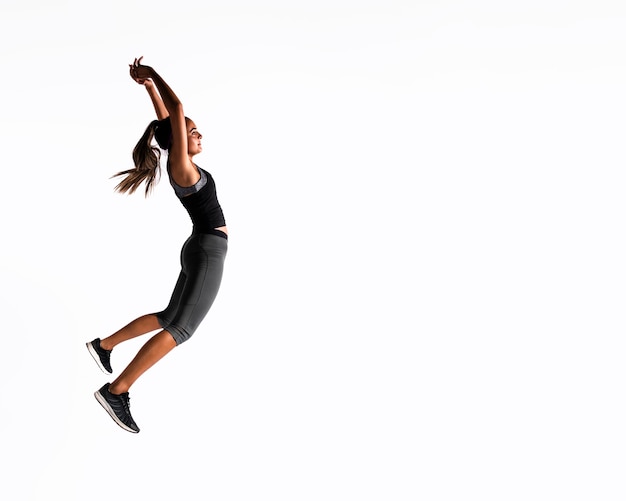 Free photo full shot woman jumping indoors