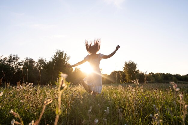 Full shot woman jumping outdoors