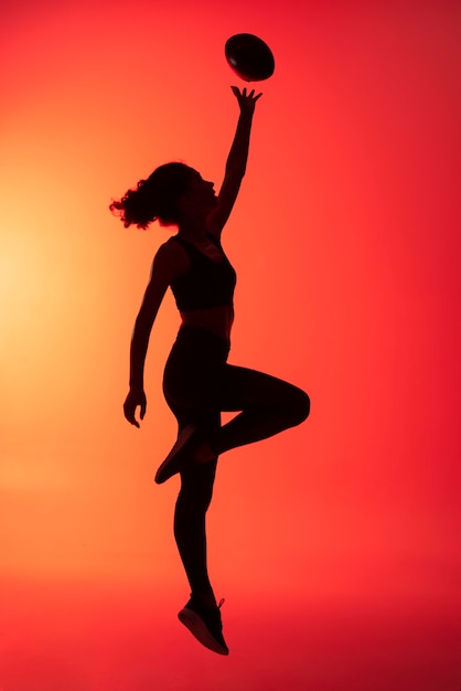 Full shot woman jumping with ball