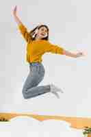 Free photo full shot woman jumping with headphones