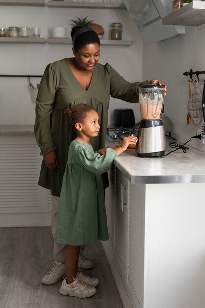 full shot woman and kid at home