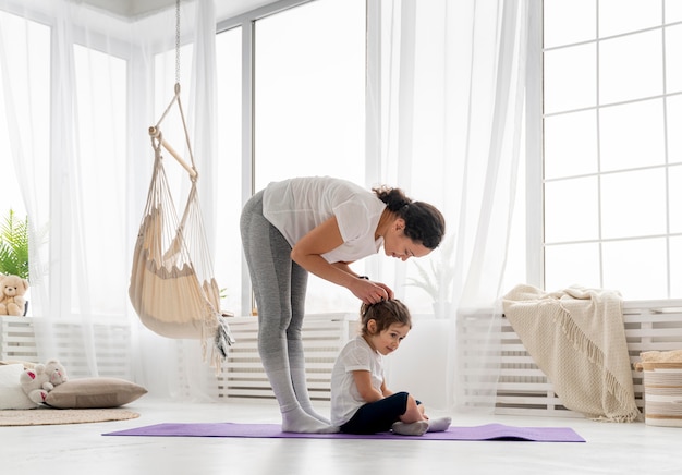 Full shot woman and kid indoors