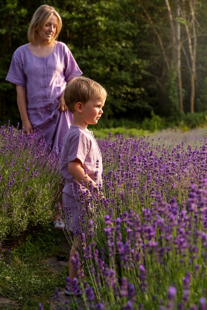Full shot woman and kid in lavender field