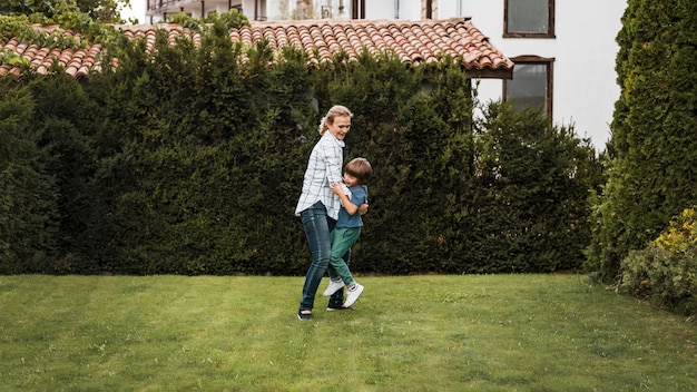 Full shot woman and kid outdoors