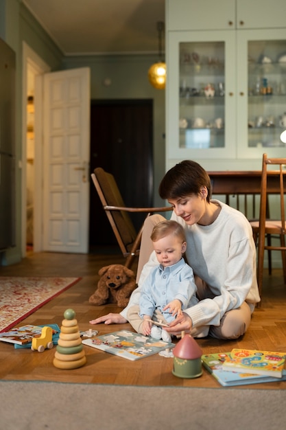 Full shot woman and kid playing