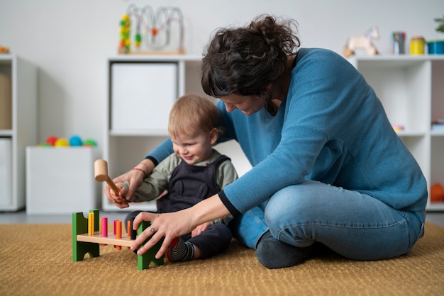 Full shot woman and kid playing