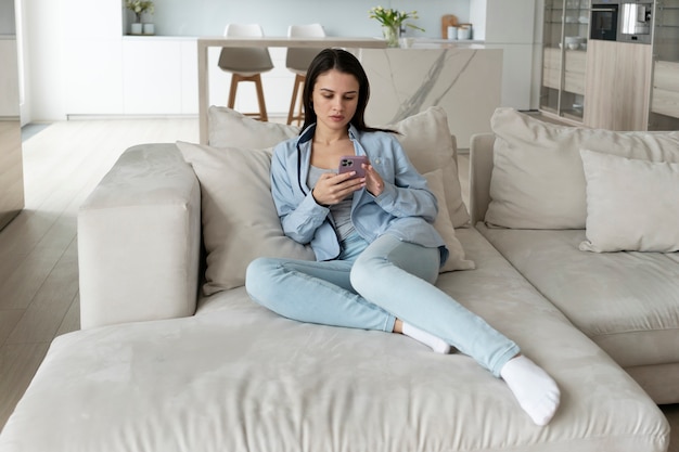 Free photo full shot woman laying on couch