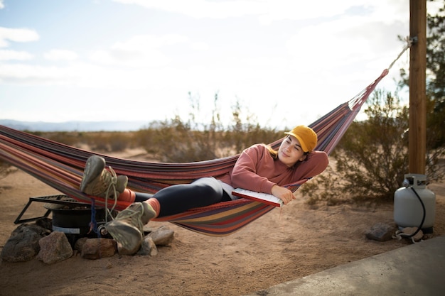 Full shot woman laying on hammock