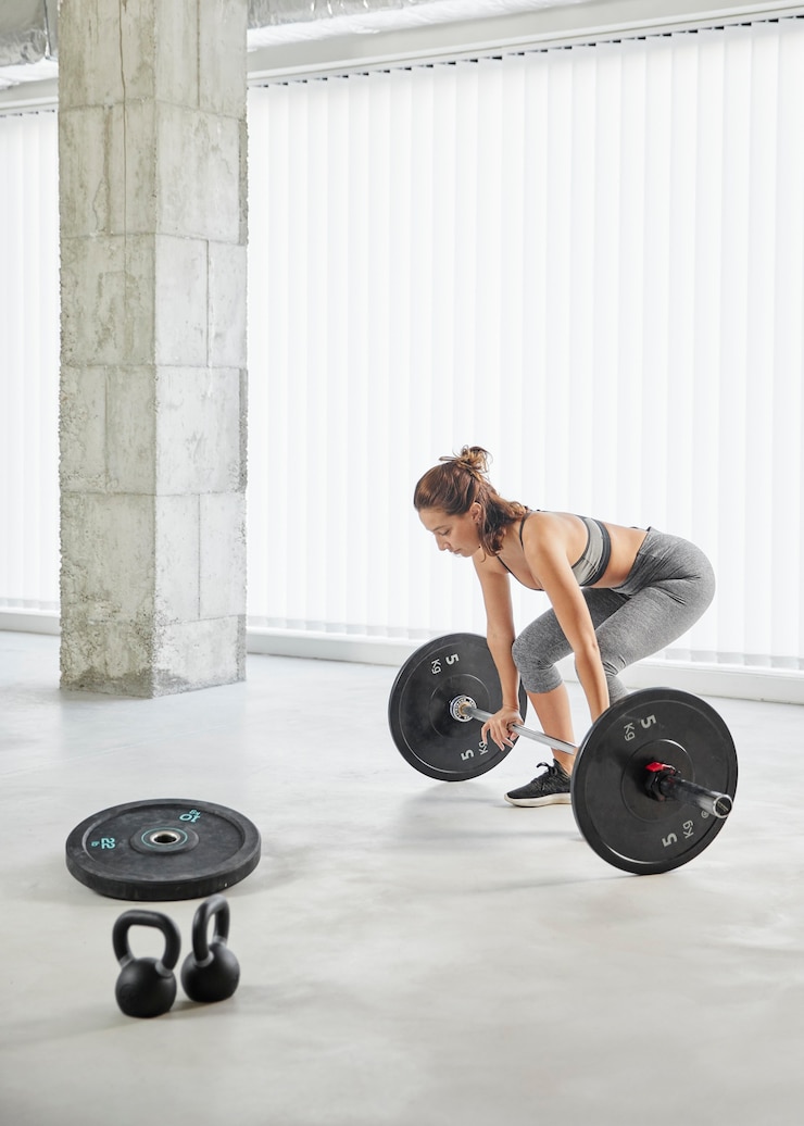 Free Photo full shot woman lifting weights