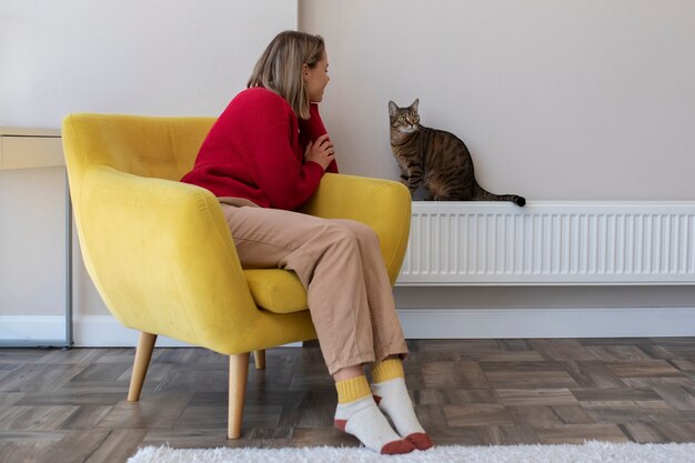 Full shot woman looking at cat