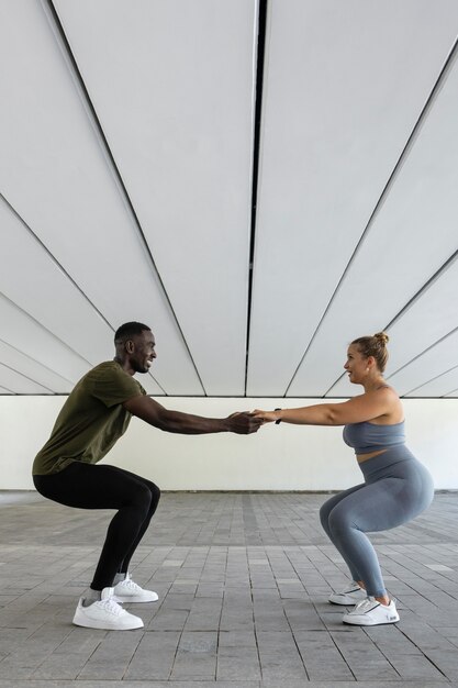 Full shot woman and man working out