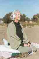 Free photo full shot woman meditating outdoors