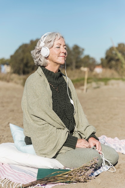 Full shot woman meditating outdoors