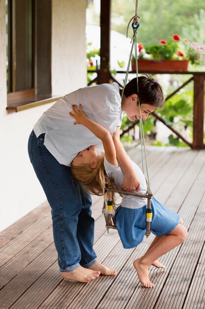 Full shot woman playing with girl