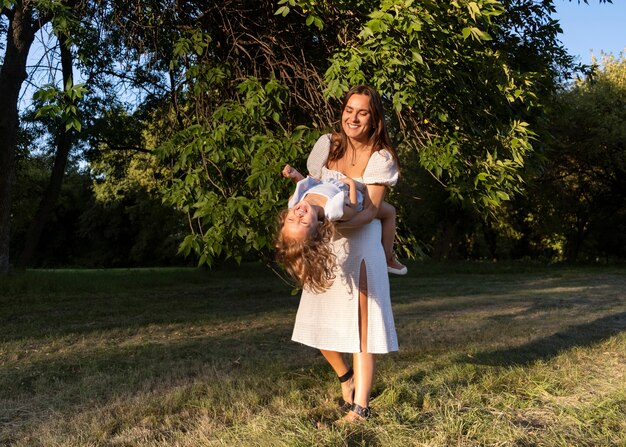 Full shot woman playing with kid