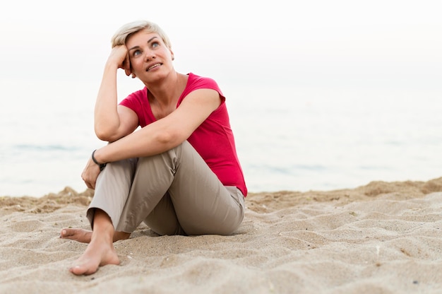 Full shot woman posing on beach