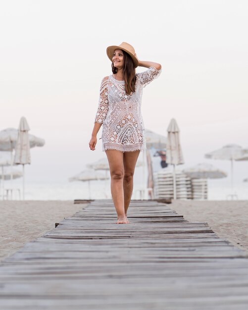 Full shot woman posing on beach