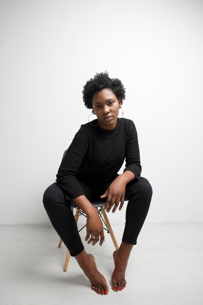 Full shot woman posing on chair