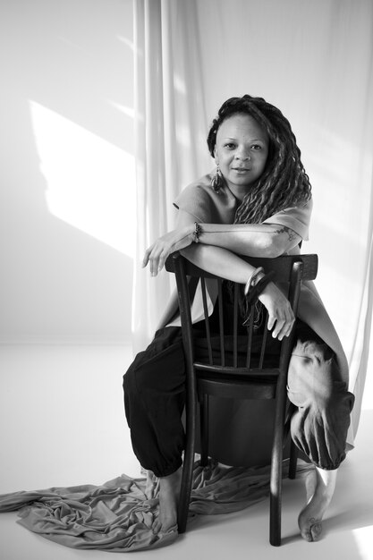 Full shot woman posing on chair