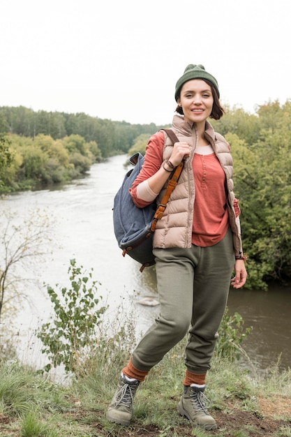 Full shot woman posing in front of river