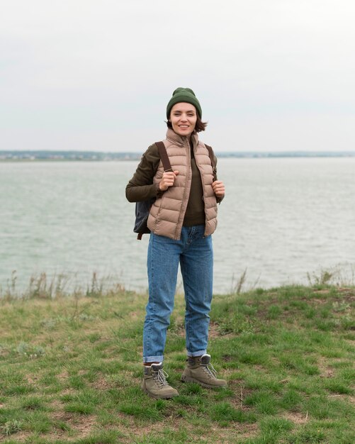 Full shot woman posing near water