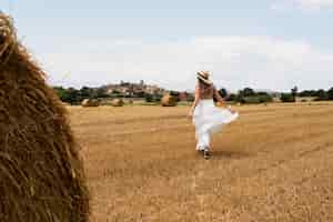 Foto gratuita donna a tutto campo in posa all'aperto