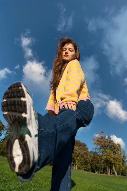 Free photo full shot woman posing outdoors