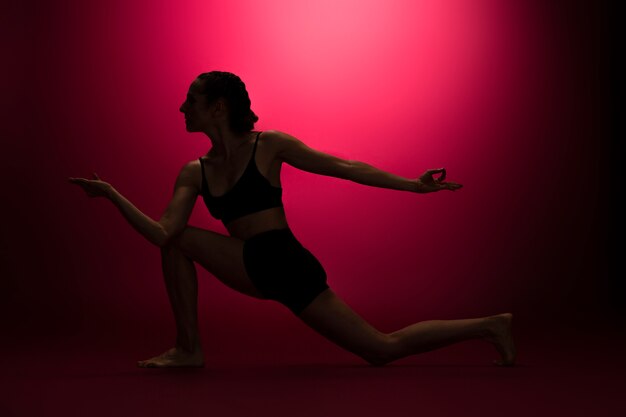 Full shot woman posing in red light