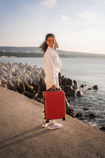 Full shot woman posing with baggage