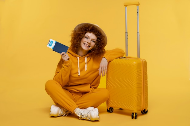 Free photo full shot woman posing with baggage