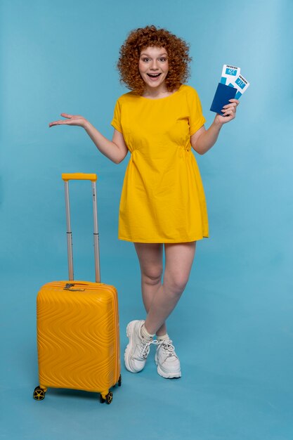 Full shot woman posing with baggage