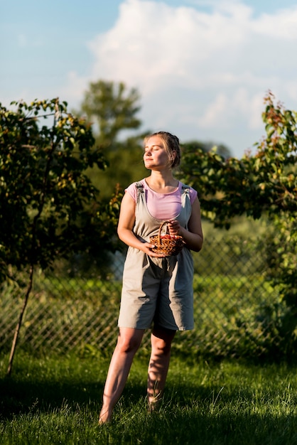 Full shot woman posing with basket