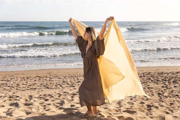 Full shot woman posing with cloth