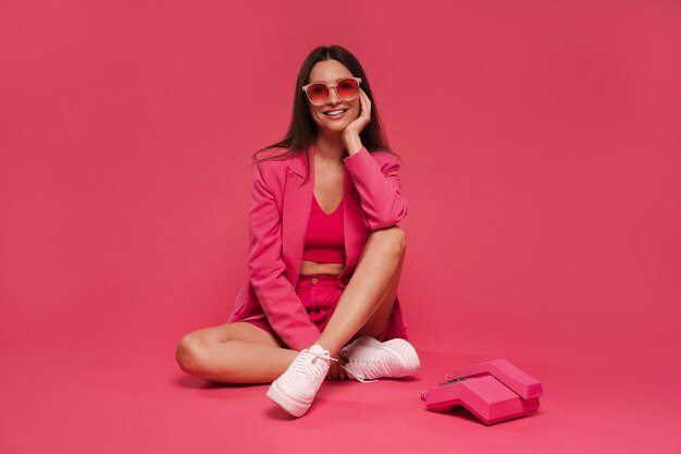 Full shot woman posing with pink outfit