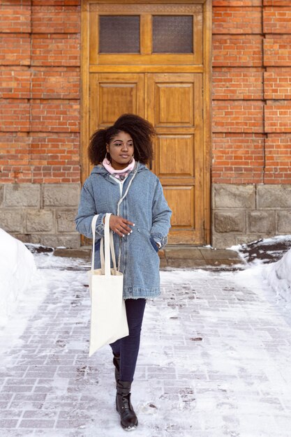 Full shot woman posing with snow