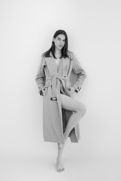 Full shot woman posing with trench coat