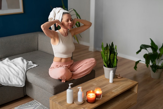 Full shot woman practicing facial yoga