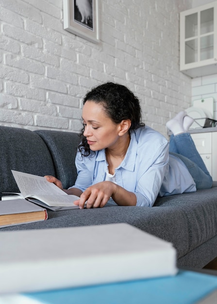 Full shot woman reading book