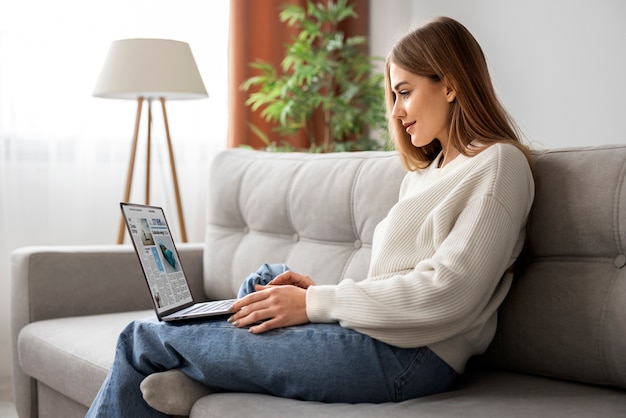 Free photo full shot woman reading digital magazine