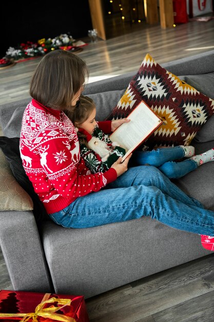 Full shot woman reading to girl